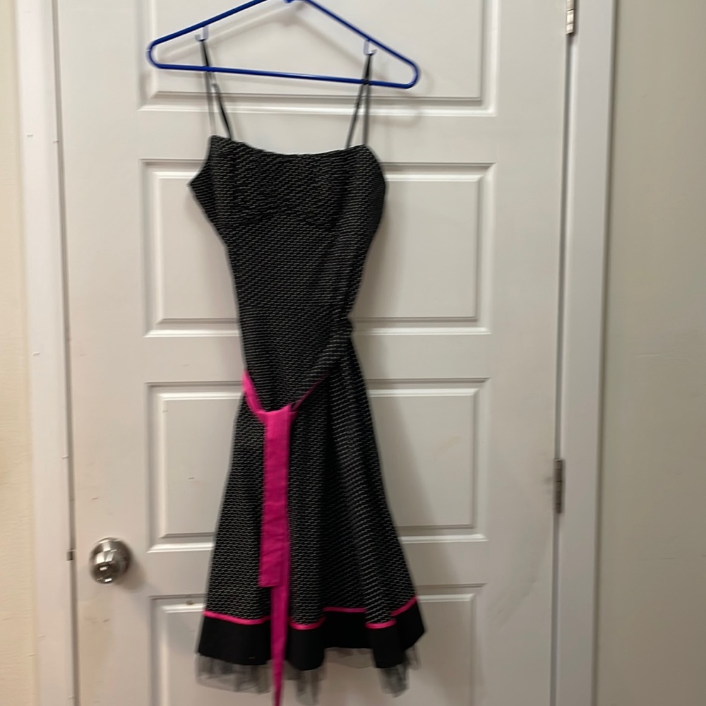In great condition spaghetti strap, black and white polka-dot with pink trim.
